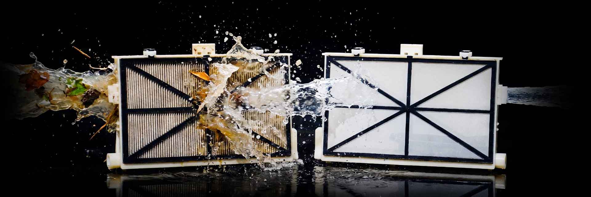 Dolphin Sigma NanoFilter cartridge loaded with debris next to a clean NanoFilter
